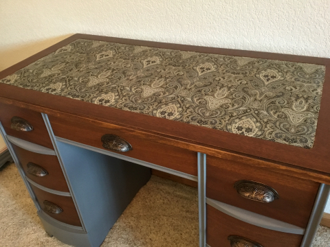 Fabric replaces the damaged leather insert.