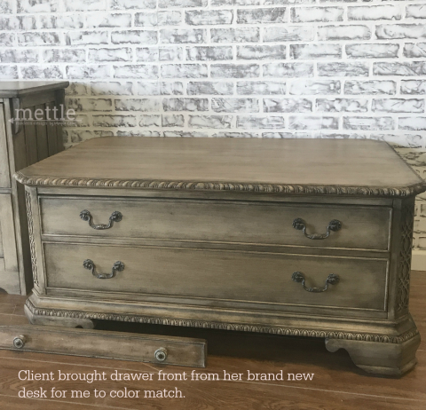 Client's brand new drawer front for color match, in front of the finished pieces.
